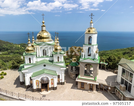 Christian church in the mountains above the sea. Temple of the Holy Archangel Michael in Oreanda. The southern coast of Crimea. Aerial view Christian church in the mountains above the sea. Temple of the Holy Archangel Michael in Oreanda. The southern coast of Crimea. Aerial view 97505157