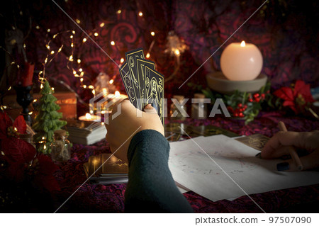 Tarot reader or Fortune teller reading on Christmas decoration. Tarot reader or Fortune teller reading on Christmas decoration. 97507090