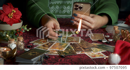 Tarot reader or Fortune teller reading on Christmas decoration. 97507095