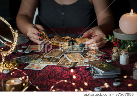 Tarot reader or Fortune teller reading on Christmas decoration. 97507096