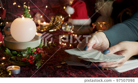 Tarot reader or Fortune teller reading on Christmas decoration. Tarot reader or Fortune teller reading on Christmas decoration. 97507098