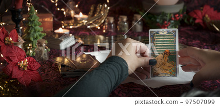 Tarot reader or Fortune teller reading on Christmas decoration. Tarot reader or Fortune teller reading on Christmas decoration. 97507099
