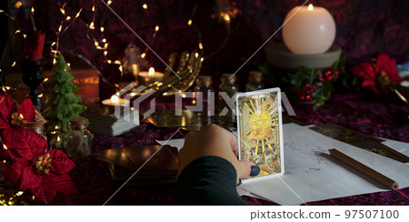 Tarot reader or Fortune teller reading on Christmas decoration. Tarot reader or Fortune teller reading on Christmas decoration. 97507100