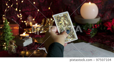 Tarot reader or Fortune teller reading on Christmas decoration. Tarot reader or Fortune teller reading on Christmas decoration. 97507104