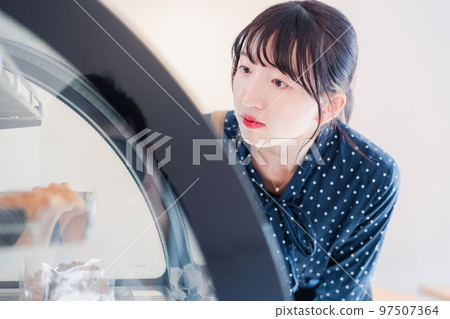 A young woman posting a review of a shop 97507364