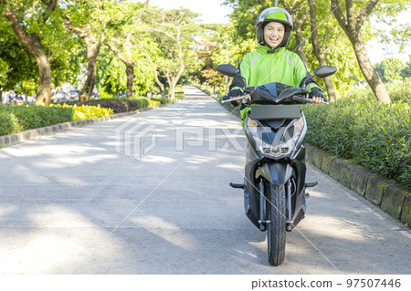 Asian woman works as a motorcycle taxi driver 97507446