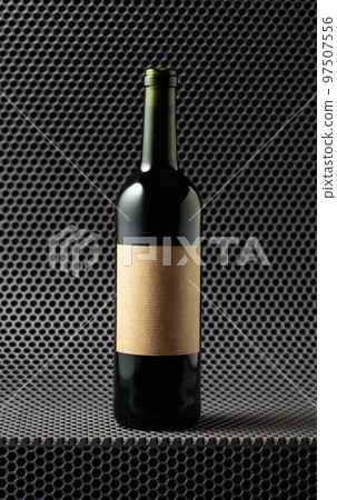 Bottle of red wine on a grey cellular background. 97507556
