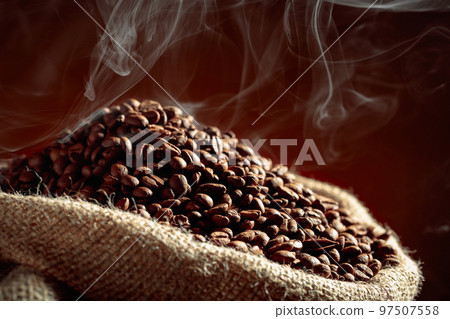Coffee beans are smoky in a burlap bag. 97507558