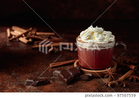 Hot chocolate with ingredients on a brown table. Hot chocolate with ingredients on a brown table. 97507559