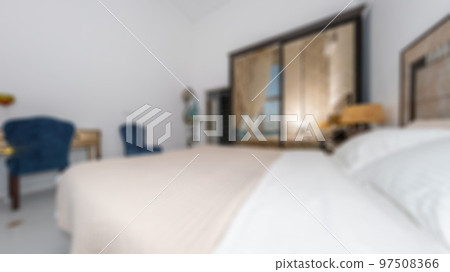 Defocused and blurred photo of luxury and modern bedroom with sea view in hotel apartment interior design. Ideal for background. Defocused and blurred photo of luxury and modern bedroom with sea view in hotel apartment interior design. Ideal for background. 97508366