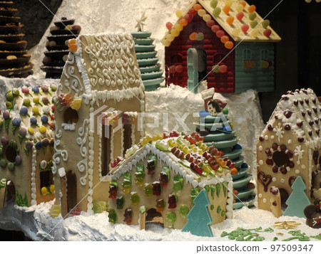 Christmas Gingerbread and chocolate House decorated with candy canes, marshmallow cones gummy bears Christmas Gingerbread and chocolate House decorated with candy canes, marshmallow cones gummy bears 97509347
