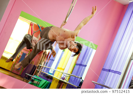 Ukrainian gymnast doing gymnastics with aerial hoop or aerial hoop in the fitness room. Ukrainian gymnast doing gymnastics with aerial hoop or aerial hoop in the fitness room. 97512415
