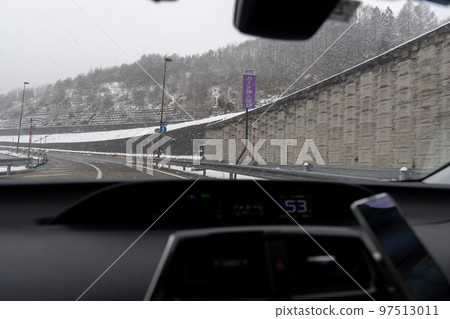 Scenery from a passenger car running on a snowy highway 97513011
