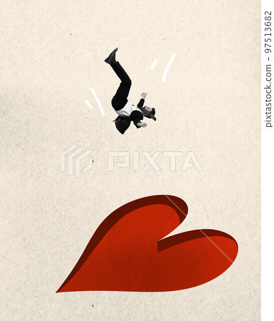 Man falling down into huge applique in heart shape over light background. Creative design for greeting card for Valentine's day holiday. Love, feelings 97513682