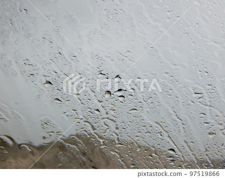 Raindrops on glass. 97519866