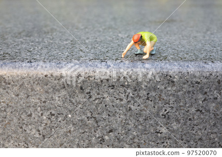 a mini figure Hikers climbing on mountain. 97520070