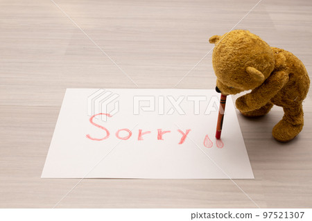 A stuffed bear that writes Sorry on paper with a crayon. 97521307