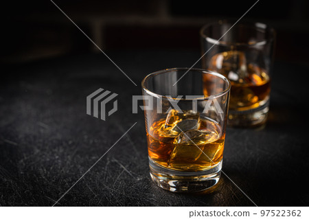 Whiskey with ice in glasses Whiskey with ice in glasses 97522362