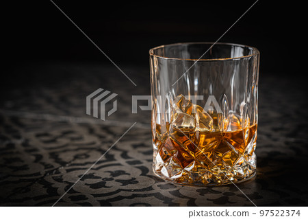 Whiskey with ice in glasses Whiskey with ice in glasses 97522374