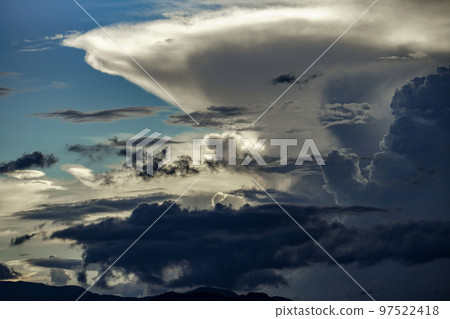 Side view of distant cumulonimbus clouds 97522418