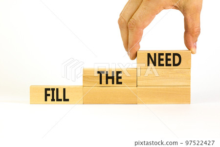 Fill the need symbol. Concept words Fill the need on wooden blocks on a beautiful white table white background. Businessman hand. Business, finacial and fill the need concept. Copy space. 97522427