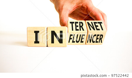 Internet influencer symbol. Concept word Internet influencer on wooden cubes. Beautiful white table white background. Businessman hand. Business internet influencer concept. Copy space. Internet influencer symbol. Concept word Internet influencer on wooden cubes. Beautiful white table white background. Businessman hand. Business internet influencer concept. Copy space. 97522442
