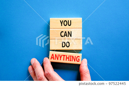 You can do anything symbol. Concept word You can do anything on wooden blocks. Businessman hand. Beautiful blue table blue background. Business and you can do anything concept. Copy space. You can do anything symbol. Concept word You can do anything on wooden blocks. Businessman hand. Beautiful blue table blue background. Business and you can do anything concept. Copy space. 97522445