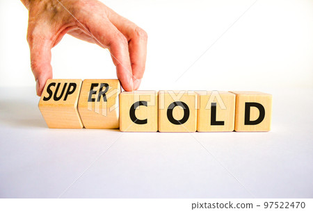 Super cold symbol. Doctor turns wooden cubes and changes concept words cold to super cold. Beautiful white table, white background, copy space. Medical and super cold concept. 97522470