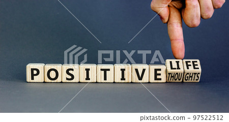 Positive thoughts and life symbol. Concept words Positive thoughts or Positive life on wooden cubes. Businessman hand. Beautiful grey background. Business positive thoughts life concept. Copy space 97522512