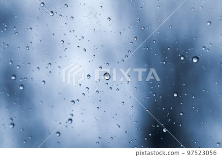 Water droplets are on a window glass on a rainy day 97523056