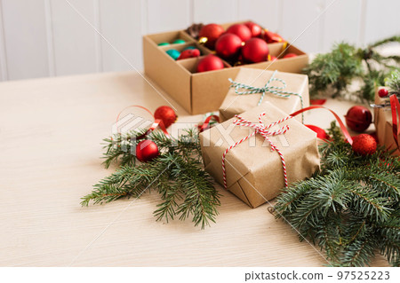 Gifts in craft paper with ribbons and bows for new year or Christmas. Preparation for the holiday Gifts in craft paper with ribbons and bows for new year or Christmas. Preparation for the holiday 97525223