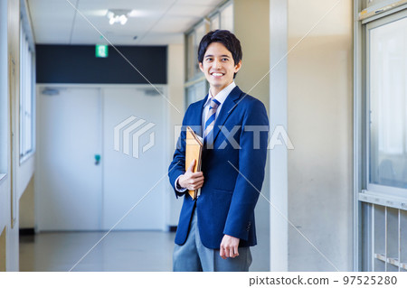 High school boy in uniform walking in the hallway High school boy in uniform walking in the hallway 97525280