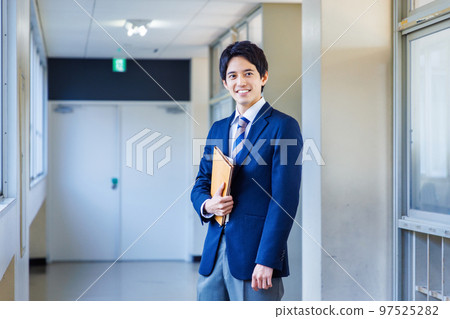 High school boy in uniform walking in the hallway 97525282