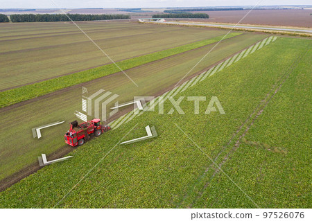 Autonomous harvester on the sugar beet field. Autonomous harvester on the sugar beet field. 97526076