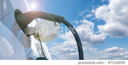 Close up of electric car with a charging station  97526099