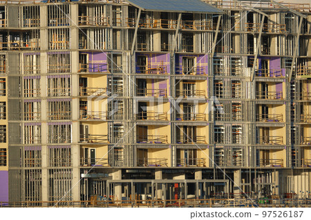 Tower lifting cranes at high residential apartment buildings construction site. Real estate development 97526187