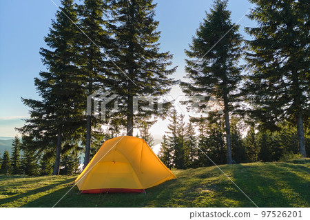 Tourist camping tent on mountain campsite at bright sunny evening. Active tourism and hiking concept 97526201