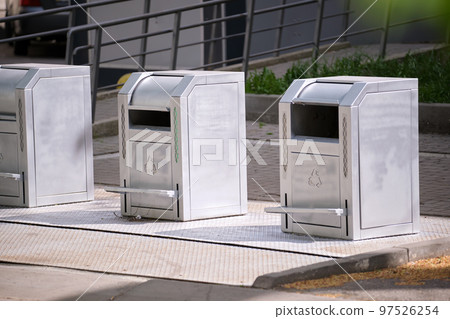 Stainless steel garbage cans for separate disposal of recycle trash on city street 97526254