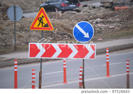 Roadworks warning traffic signs of construction work on city street Roadworks warning traffic signs of construction work on city street 97526683