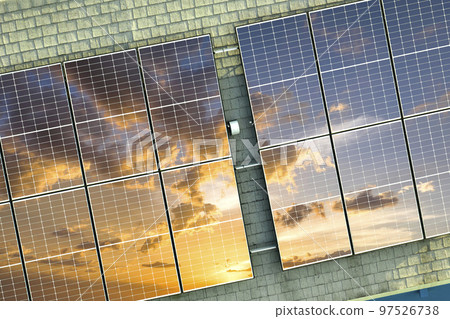 Ordinary residential house in USA with rooftop covered with solar photovoltaic panels for producing of clean ecological electrical energy in suburban rural area. Concept of autonomous home 97526738