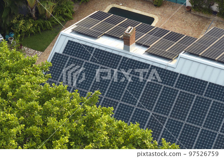 New residential house in USA with roof covered with solar panels for producing of clean ecological electricity in suburban rural area. Concept of investing in autonomous home for energy saving 97526759