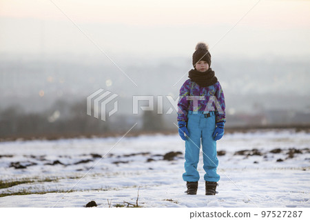 Little child boy standing outdoors alone on snow covered winter field. Little child boy standing outdoors alone on snow covered winter field. 97527287