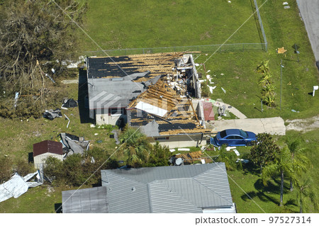 Hurricane Ian destroyed house roof in Florida residential area. Natural disaster and its consequences Hurricane Ian destroyed house roof in Florida residential area. Natural disaster and its consequences 97527314
