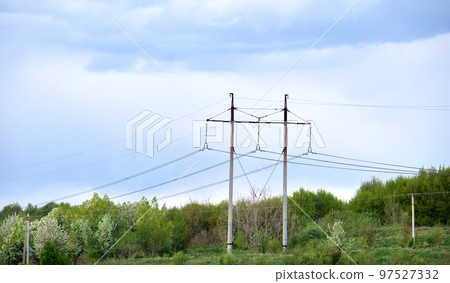 High voltage tower with electric power lines transfening electrical energy through cable wires 97527332