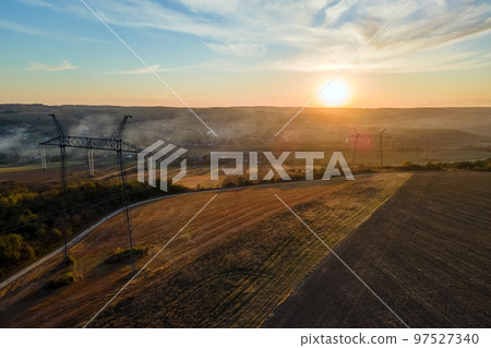 High voltage tower with electric power lines at sunset. Transmission of electricity 97527340