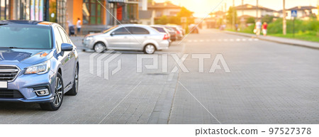 Front view of new car parked on city street side. 97527378