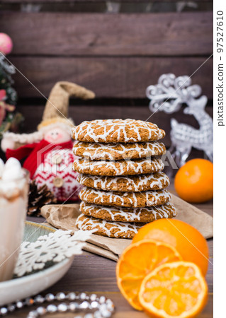 Christmas cookies and dried mandarin slices on the table in Christmas decorations 97527610