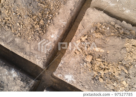 Dug out trench for building works of new house concrete foundation on construction site 97527785