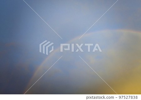 Colorful round rainbow against blue evening sky after heavy thunderstorm 97527838