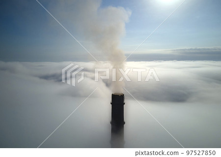 Coal power plant high pipes with black smoke moving upwards over clouds polluting atmosphere. Production of electrical energy with fossil fuel concept Coal power plant high pipes with black smoke moving upwards over clouds polluting atmosphere. Production of electrical energy with fossil fuel concept 97527850